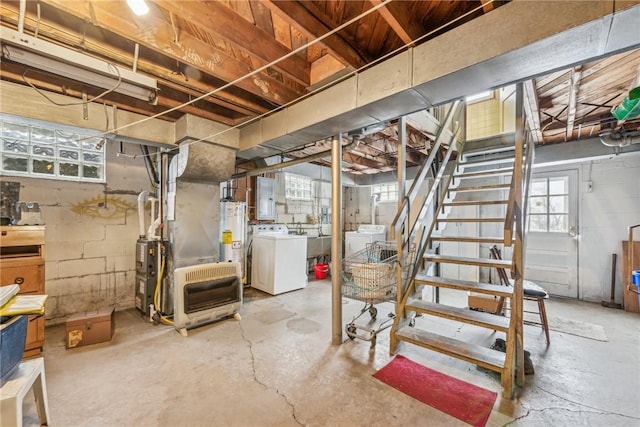 basement featuring gas water heater, electric panel, independent washer and dryer, and stairway