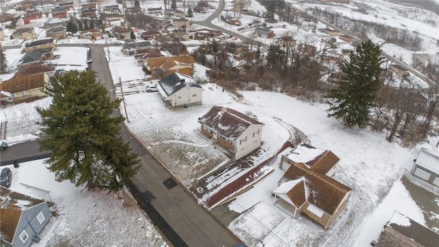 snowy aerial view with a residential view