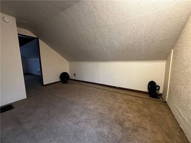 bonus room with carpet floors, a textured ceiling, and lofted ceiling