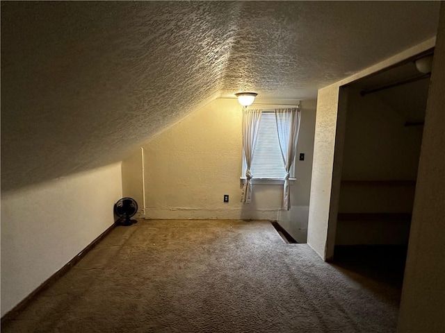 additional living space featuring carpet floors, lofted ceiling, a textured wall, and a textured ceiling