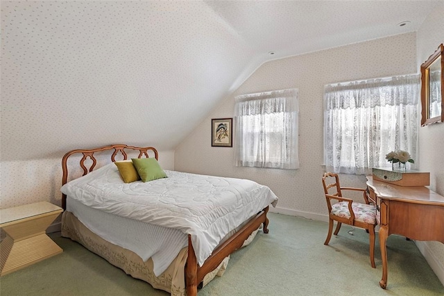 bedroom with light colored carpet, vaulted ceiling, baseboards, and wallpapered walls