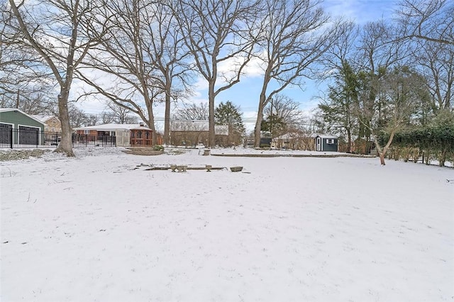 yard layered in snow with a detached garage