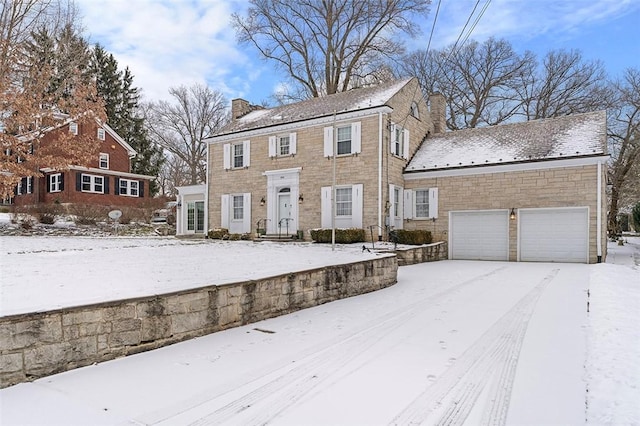 colonial home with stone siding and a chimney