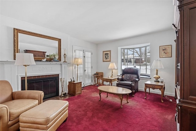 carpeted living area with a fireplace with flush hearth and baseboards