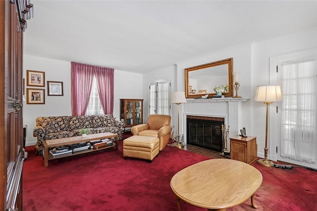 living room with a fireplace and carpet flooring