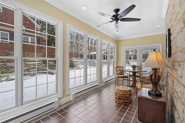 sunroom featuring ceiling fan and baseboard heating