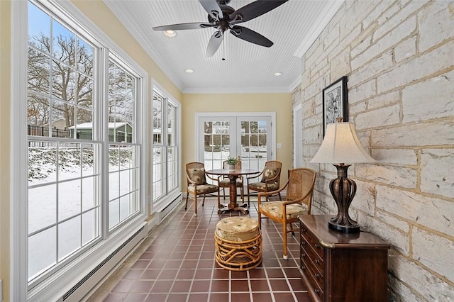 sunroom / solarium featuring a ceiling fan and baseboard heating