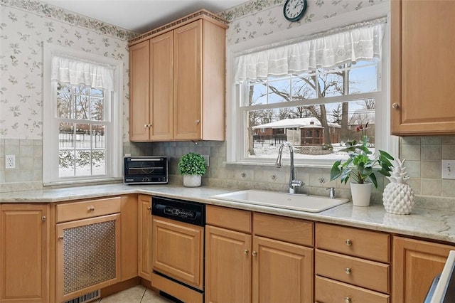 kitchen with a toaster, a sink, paneled dishwasher, and wallpapered walls