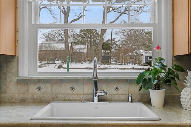 interior details with light countertops and a sink