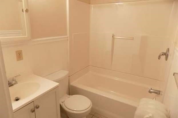 full bath featuring bathtub / shower combination, vanity, and toilet