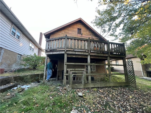 back of house featuring a deck