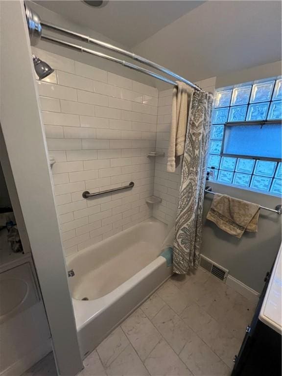 full bath featuring marble finish floor, visible vents, and shower / bath combo with shower curtain