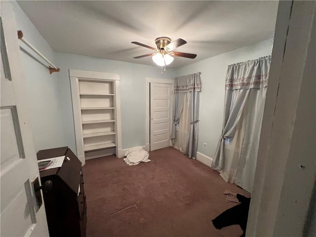 bedroom featuring a ceiling fan, dark carpet, and baseboards