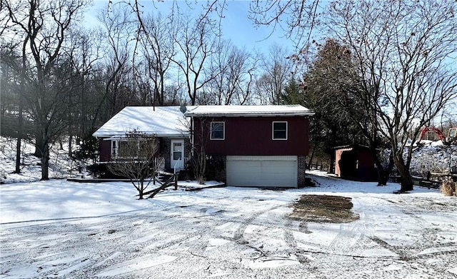 view of front of home with brick siding and an attached garage