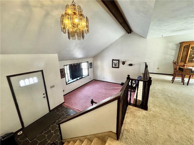 interior space with lofted ceiling with beams, a chandelier, and dark colored carpet