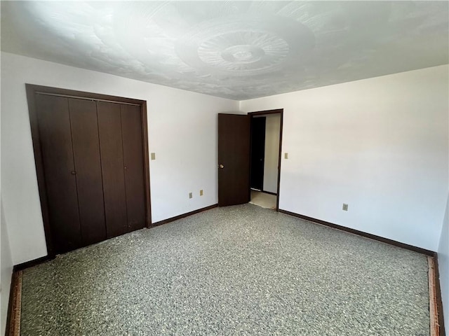 unfurnished bedroom featuring a closet and baseboards