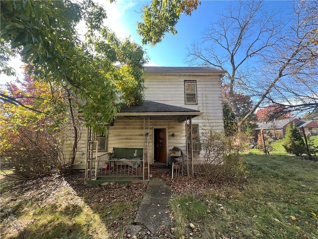 rear view of property with a lawn