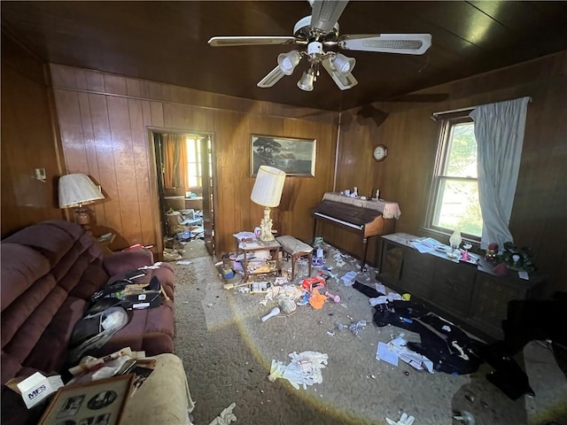 interior space with wood walls and ceiling fan