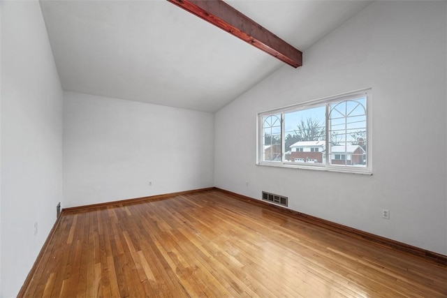 additional living space with lofted ceiling with beams, wood finished floors, visible vents, and baseboards