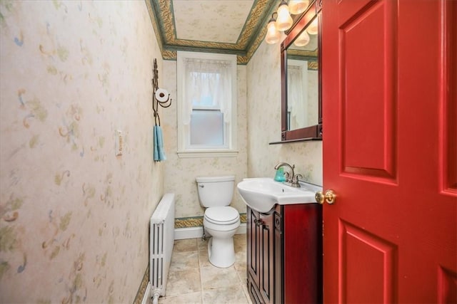 bathroom featuring radiator, vanity, toilet, and wallpapered walls