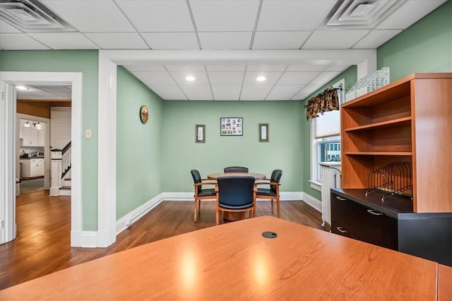 home office featuring dark wood-style floors, baseboards, and visible vents