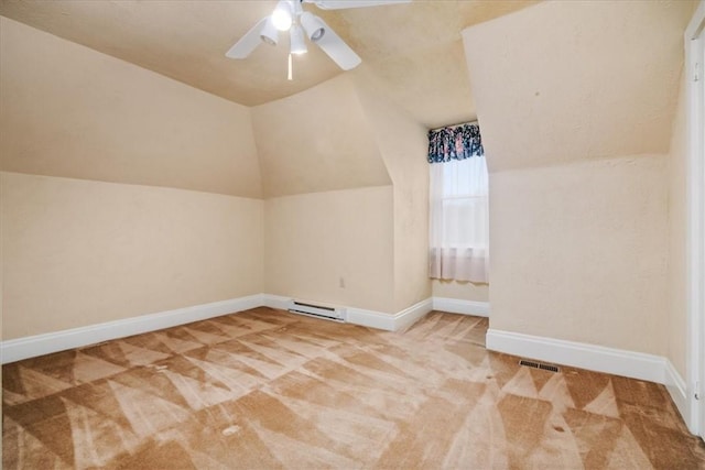 additional living space with carpet floors, lofted ceiling, visible vents, a ceiling fan, and baseboards