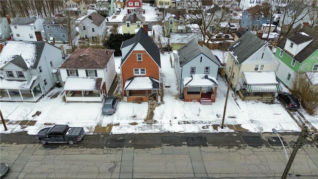 snowy aerial view with a residential view