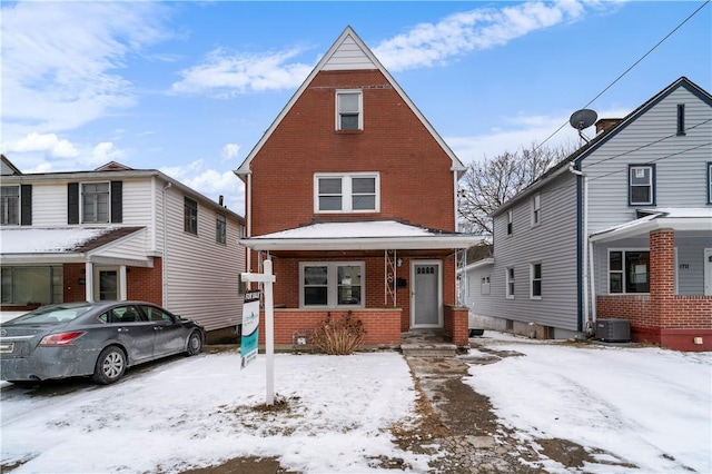 view of front of home featuring brick siding and central air condition unit