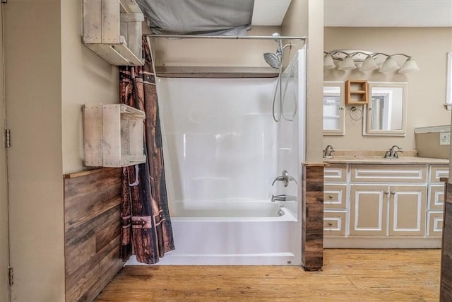 full bath featuring wood finished floors, vanity, and shower / tub combo with curtain