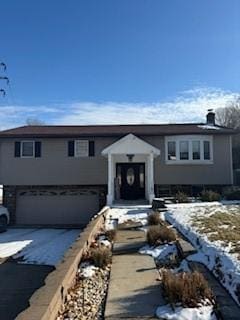 view of front of home with driveway and an attached garage