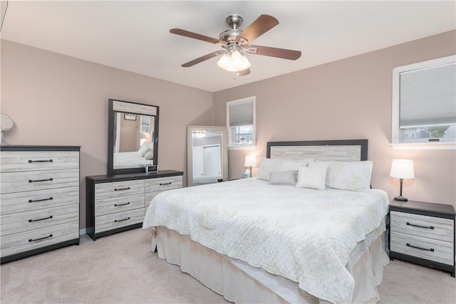 bedroom featuring light colored carpet and ceiling fan