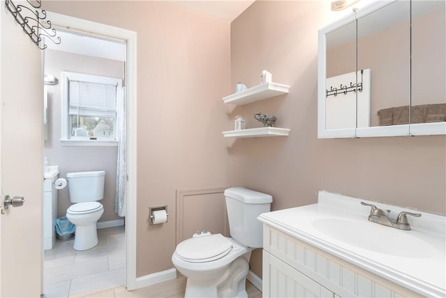 full bath featuring toilet, baseboards, and vanity