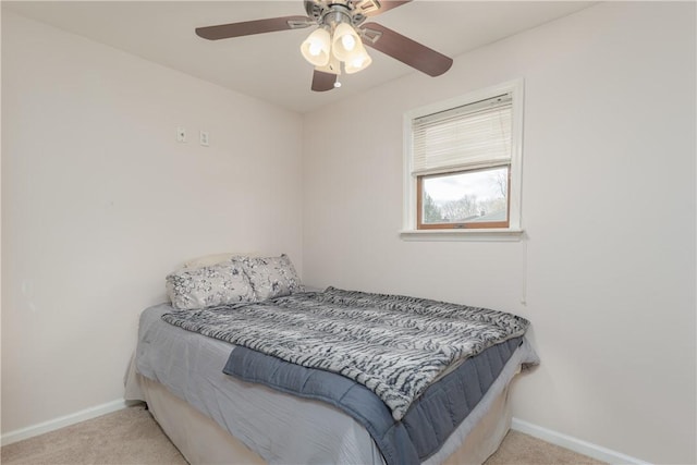 bedroom with baseboards, a ceiling fan, and light colored carpet