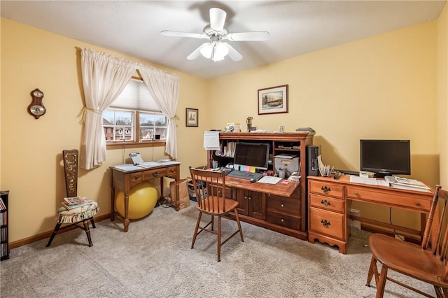 office featuring ceiling fan, baseboards, and light colored carpet