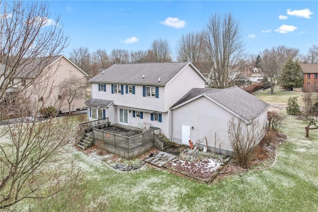 back of property with stairway, a lawn, and a wooden deck