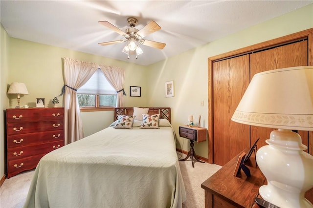 bedroom with a ceiling fan, light colored carpet, and baseboards