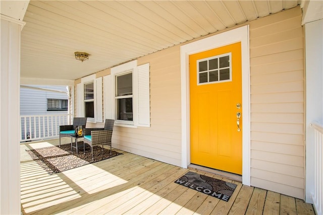 view of exterior entry with covered porch