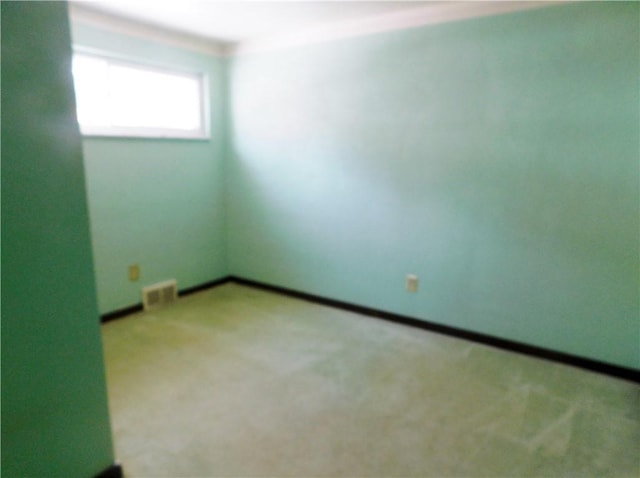 unfurnished room featuring light carpet