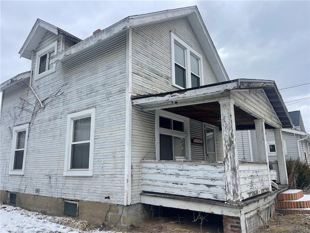 view of side of home with covered porch