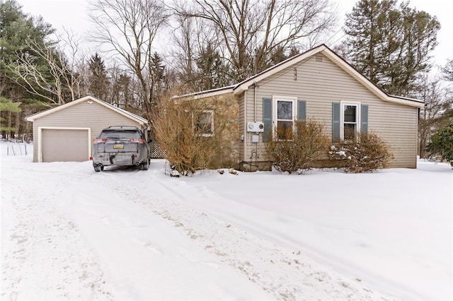 view of front of house with a garage and an outdoor structure