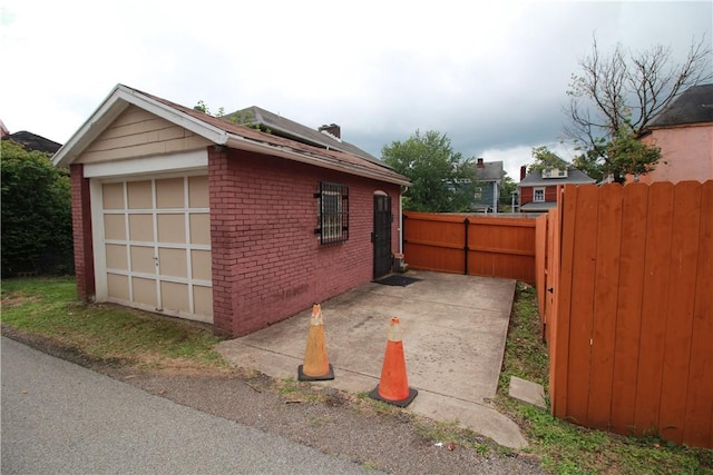 754 N Sheridan Ave, Highland Park, PA 15206 - view of home's exterior with brick siding, a patio area, a garage, and an outdoor structure