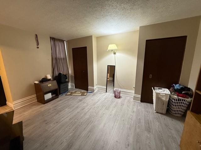 754 N Sheridan Ave, Highland Park, PA 15206 - unfurnished living room featuring wood finished floors and a textured ceiling