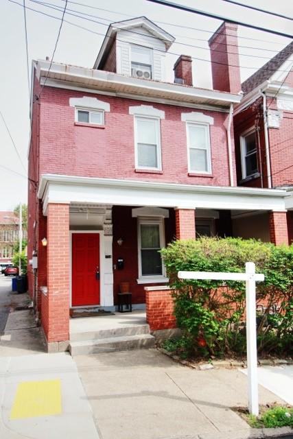 754 N Sheridan Ave, Highland Park, PA 15206 - townhome / multi-family property with brick siding and covered porch
