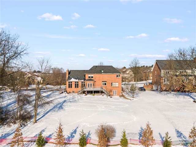 snow covered property with stairway