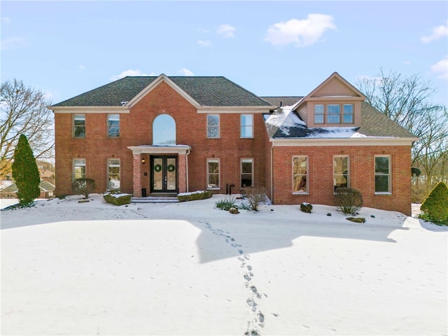 colonial-style house with brick siding