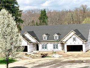 view of front of property featuring a garage and dirt driveway