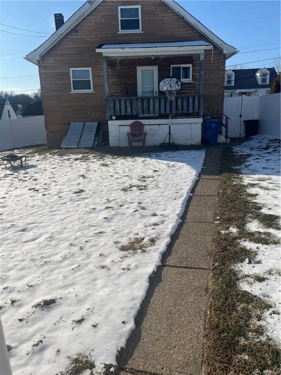 rear view of property featuring fence