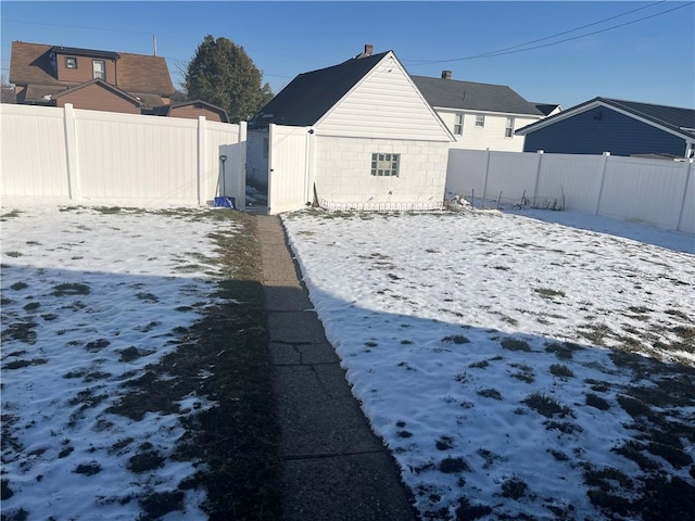 yard covered in snow with a fenced backyard