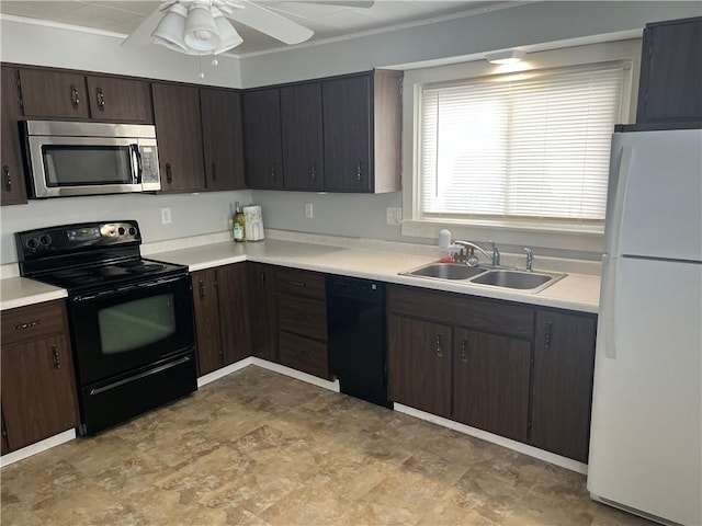 kitchen with a sink, black appliances, light countertops, and dark brown cabinetry