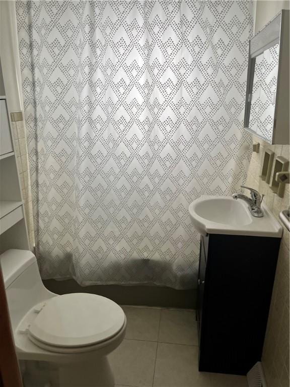 bathroom featuring toilet, vanity, and tile patterned floors